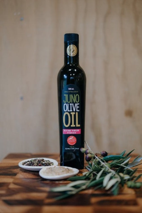 Dark green bottle of Juno Olive Oil. Frantoio Variety