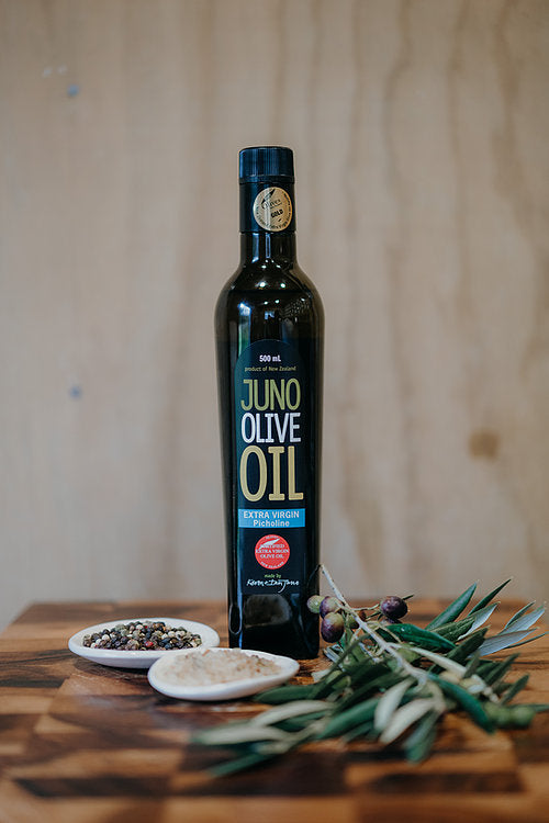 Dark green bottle of Juno Olive Oil. Picholine Variety