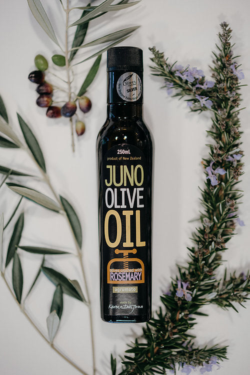 250 mL dark green bottle of Blood Rosemary agrumato oil, surrounded by olive branches and Rosemary.