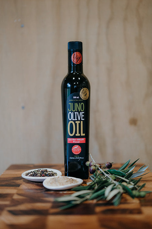 Dark green bottle of Juno Olive Oil. Picual Variety